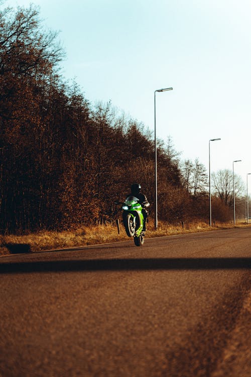 A Person Riding a Sports Bike Doing Wheelie