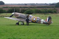 Gray and Red Jet Plane on Green Grass Field
