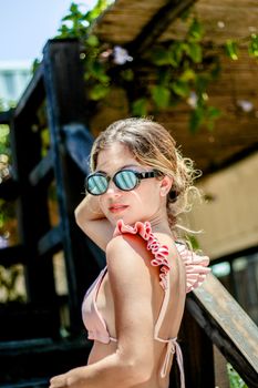Stylish woman in sunglasses enjoying summer at Adicora Beach, Venezuela.