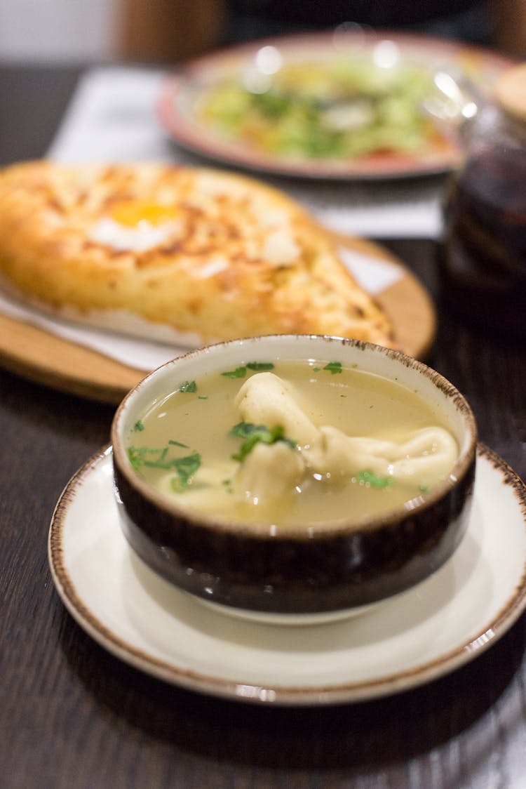 Ceramic Bowl With Soup On A Saucer