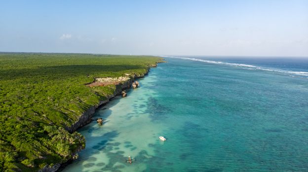 Stunning aerial view of the Mzambarauni coastline in Tanzania with vibrant turquoise waters.