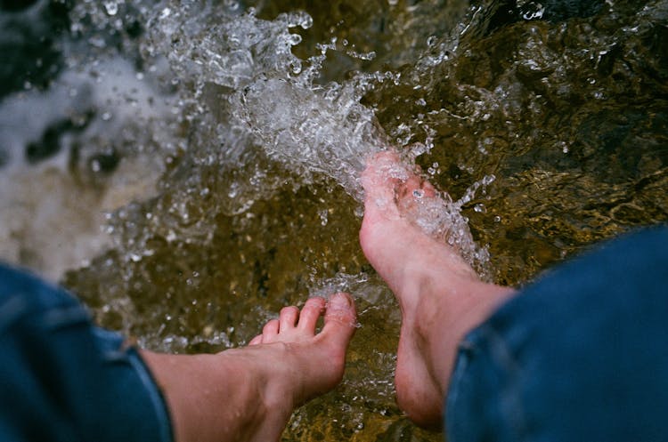 Person Washing Feet In Stream