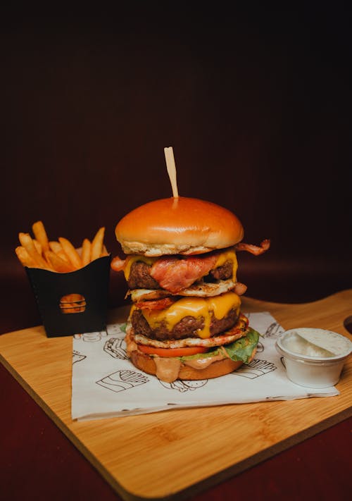 Free Delicious Burger and Fries on a Wooden Surface Stock Photo