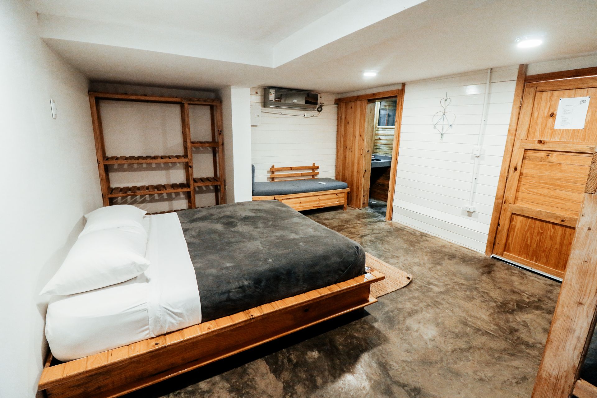 Cozy rustic bedroom featuring wooden furniture and modern amenities, perfect for a serene retreat.