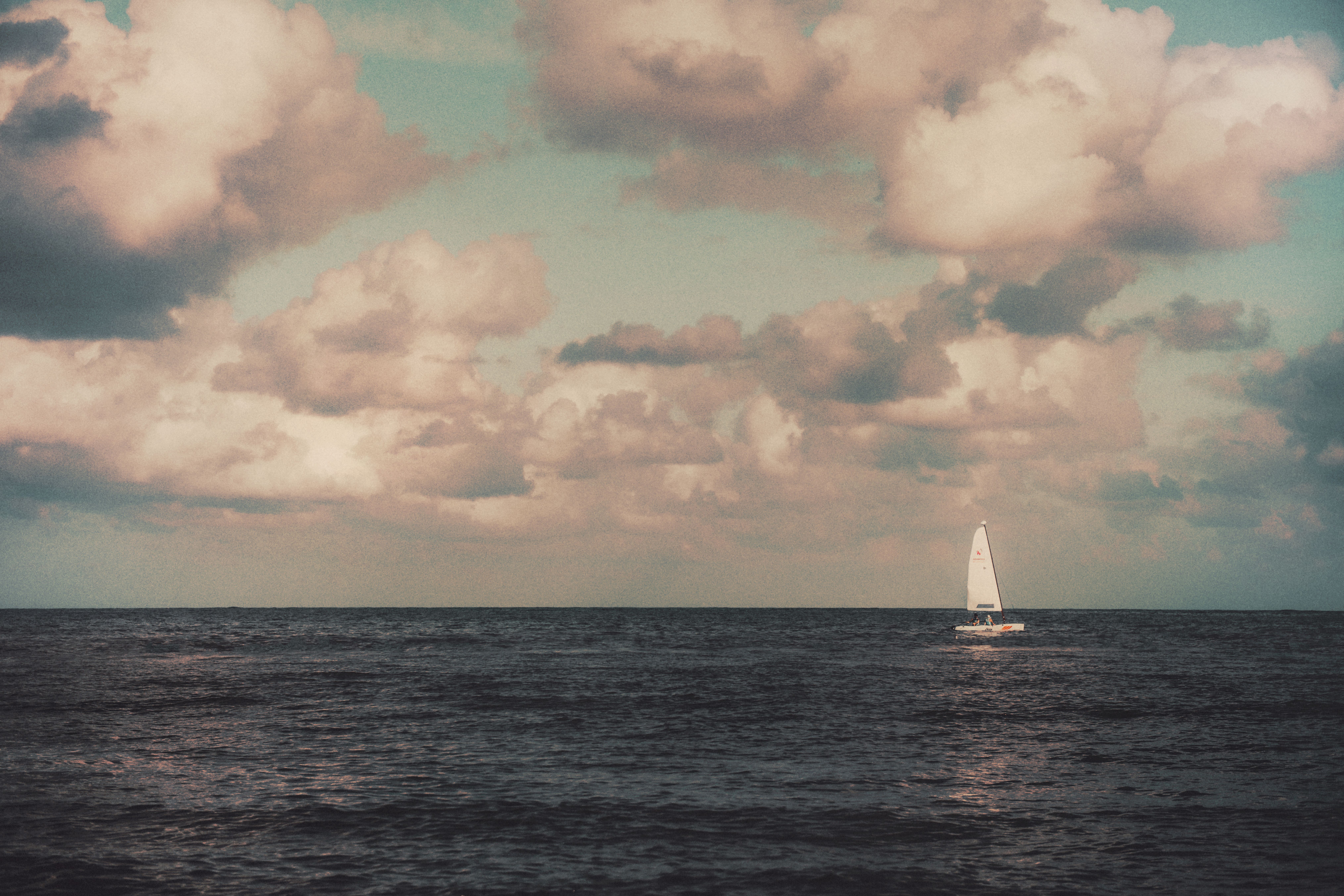 White Sailboat on Sea Under Cloudy Sky · Free Stock Photo