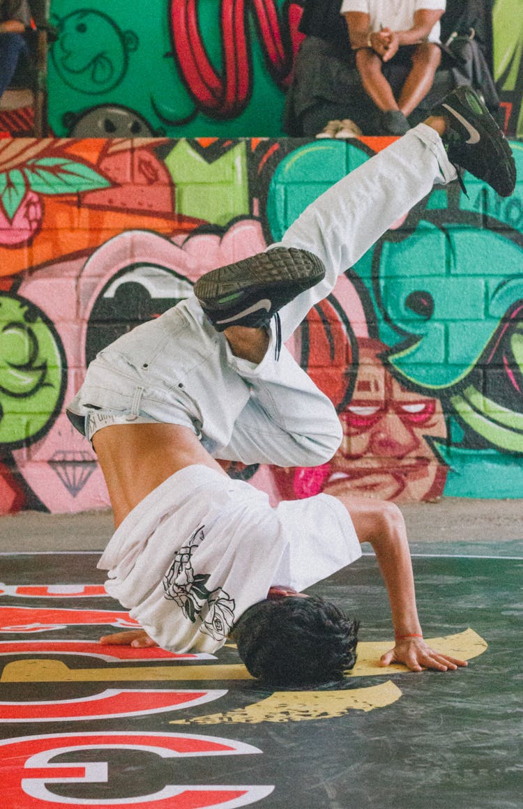 Man In White T-shirt Doing Head Stand