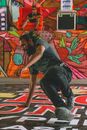 A Man in Gray Clothing Doing Street Dance