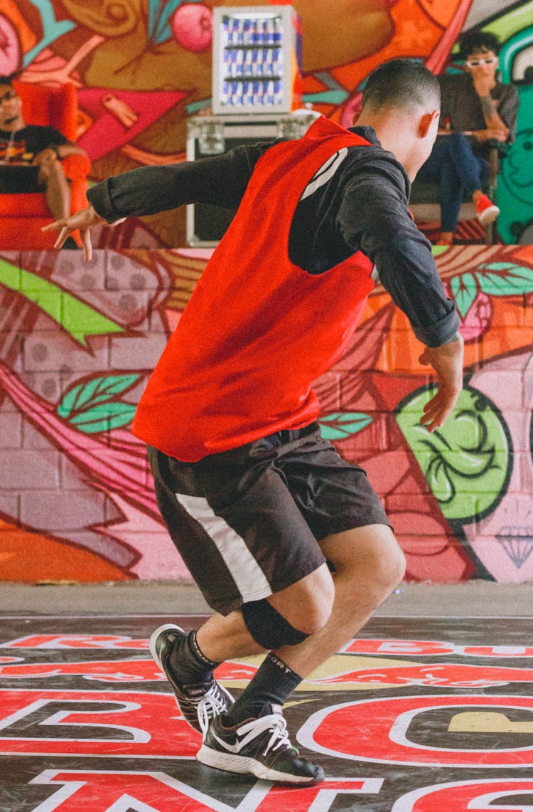 Man Street Dancing Near Mural