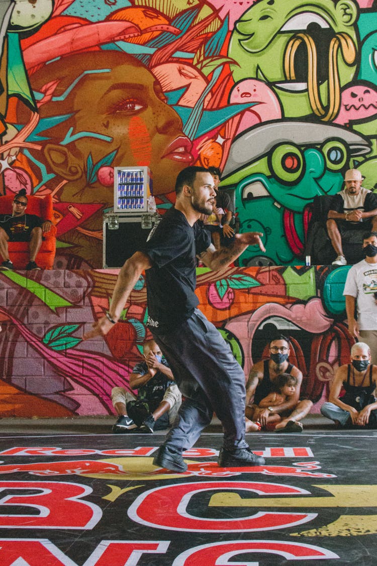 Man Dancing Near Mural 