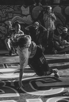 Captivating black and white shot of a breakdancer showcasing impressive skill during an urban street performance.