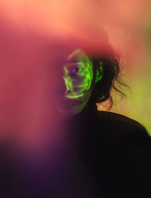 Free A mysterious portrait with vibrant neon lighting and creative blur effects. Stock Photo
