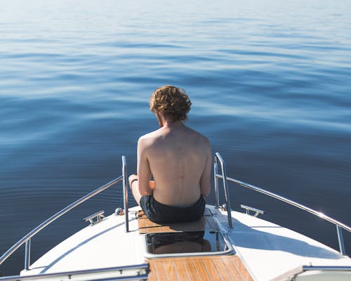 Free Man in Black Shorts on Boat End Stock Photo