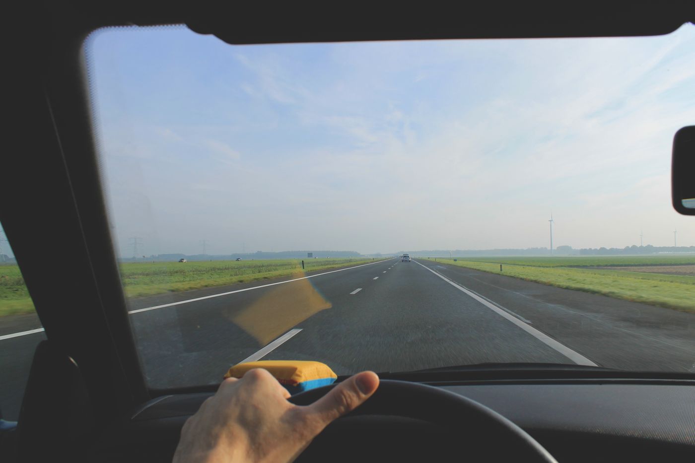View through a vehicle windshield while traveling on an open road