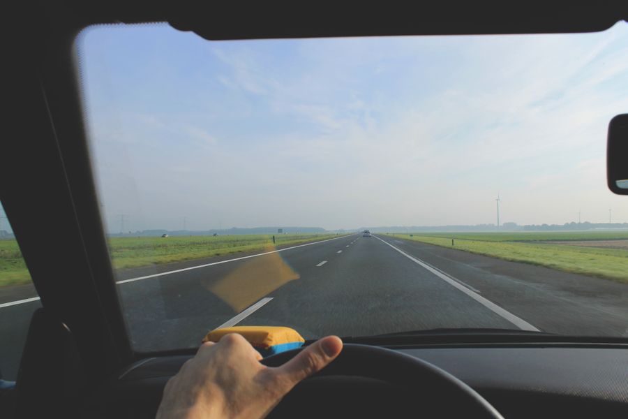 A driver's view through the windshield while driving on an open highway