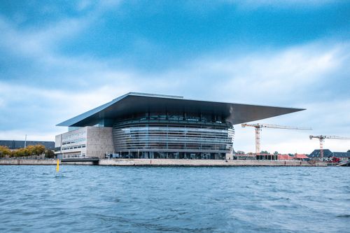 Free Modern architectural marvel, the Copenhagen Opera House, viewed from across the harbor. Stock Photo