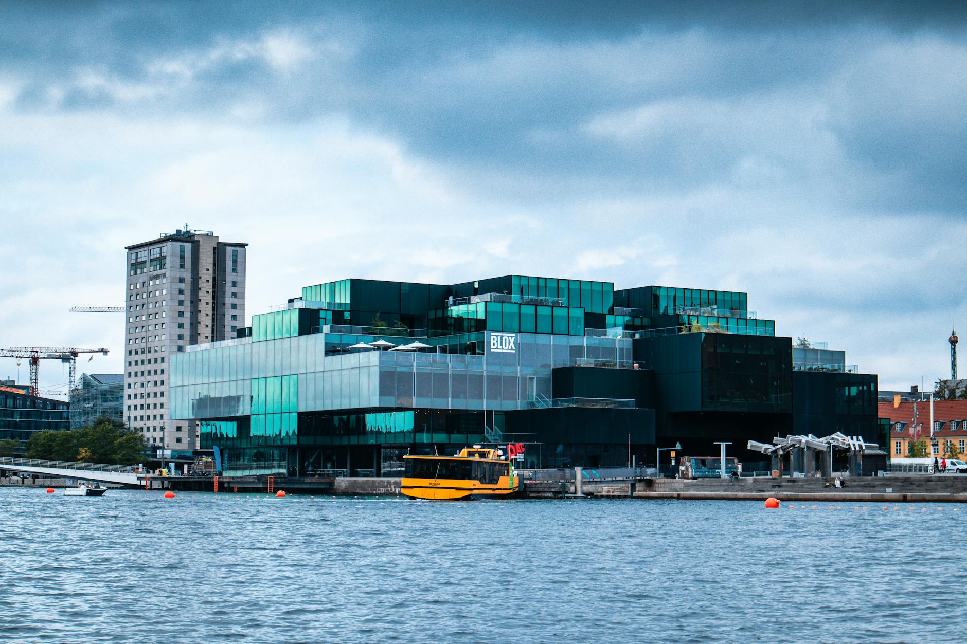 https://www.pexels.com/photo/clouds-over-buildings-near-river-in-city-11064582/