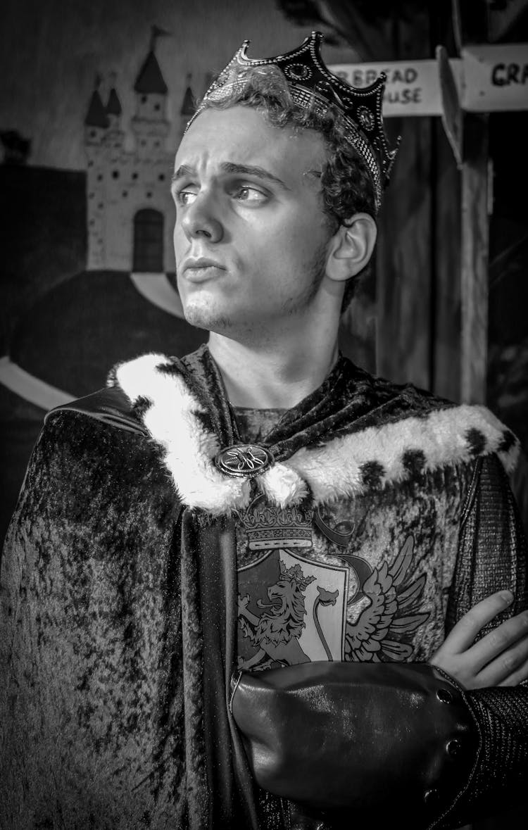 Grayscale Photo Of Man Wearing A Fur Cape And A Crown