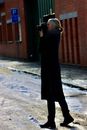 Woman in Black Coat Holding Black Camera