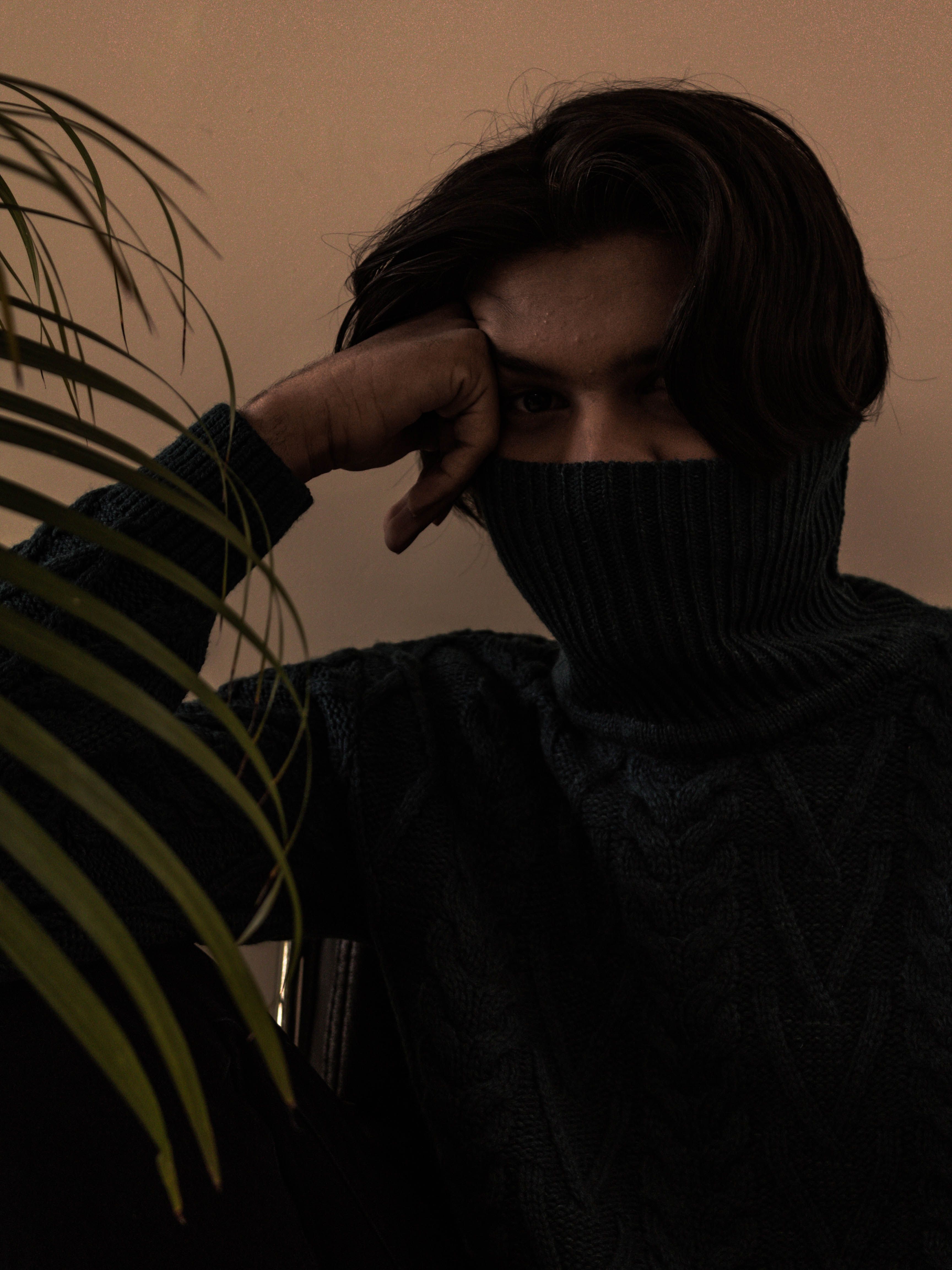 Man in Black Sweater Covering His Face with His Hand · Free Stock Photo