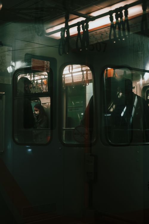 Free Moody nighttime scene inside a metro in Istanbul with passengers visible through the window. Stock Photo