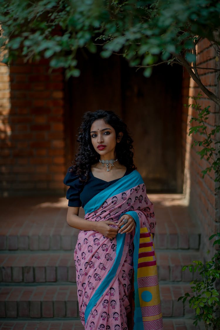 Woman In Traditional Dress Standing Near Brick Steps