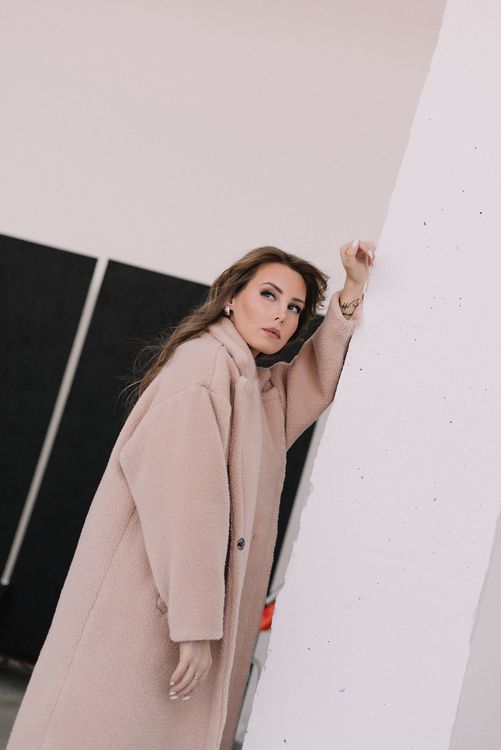 Woman in Brown Coat Posing near the Wall · Free Stock Photo