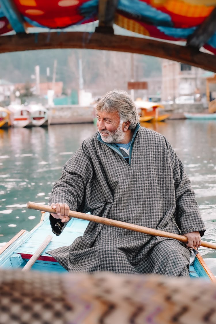 Man With Paddle In Boat