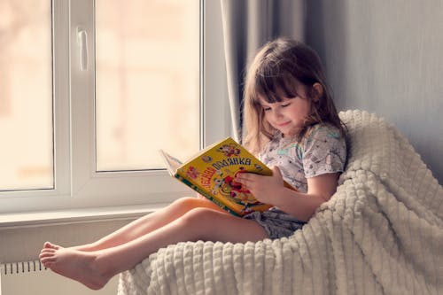 Free Cute Girl Reading a Book Stock Photo