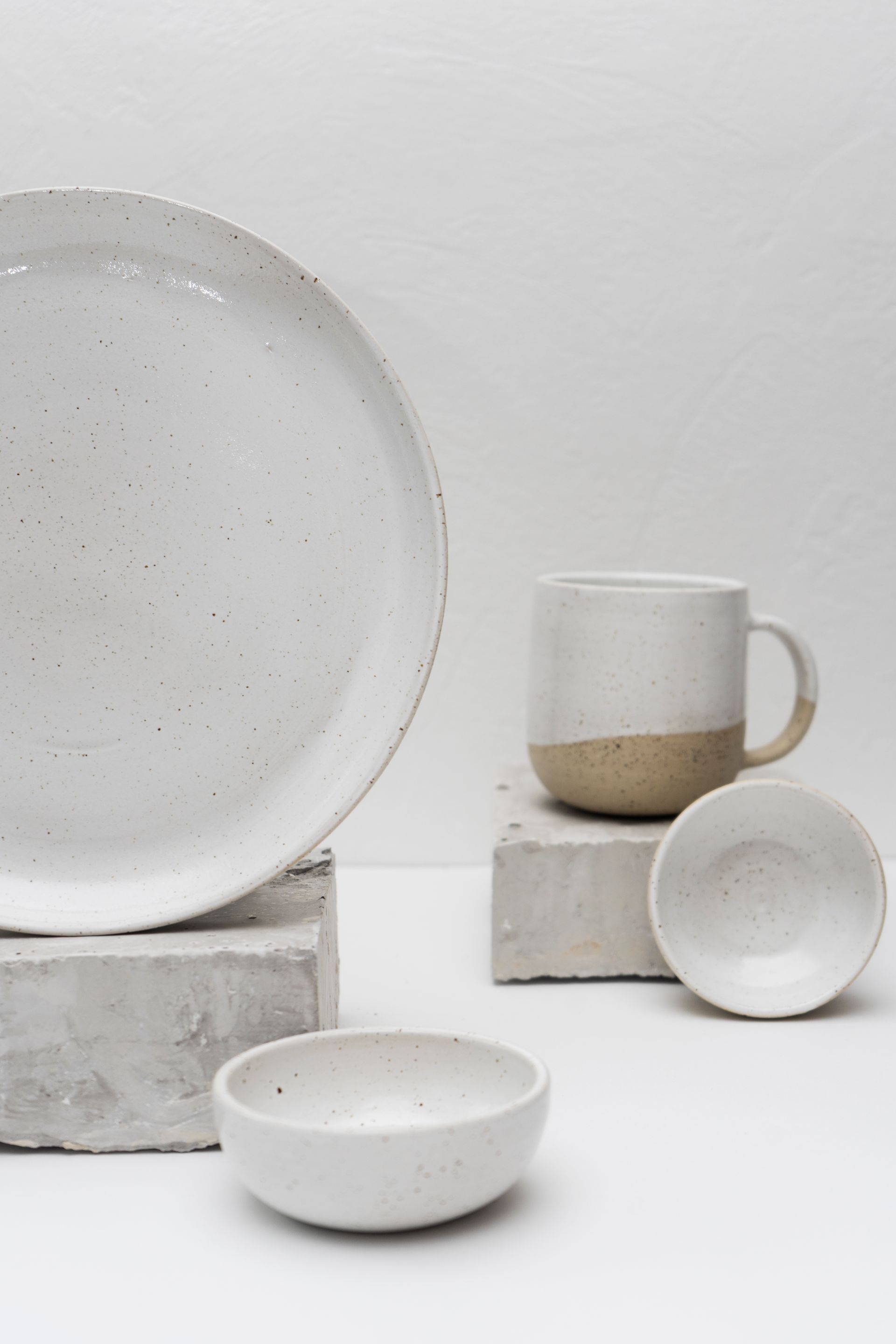 A minimalist still life of handcrafted ceramic pieces