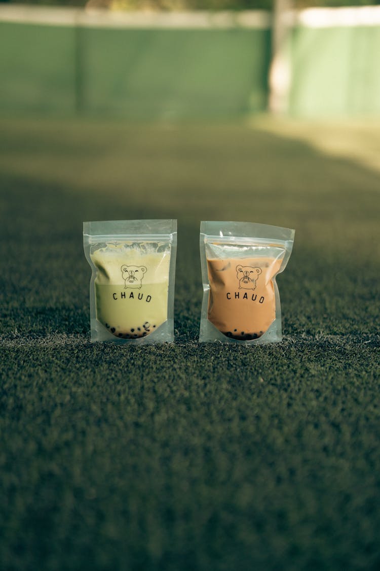 Drinks In Plastic Packaging On Green Grass