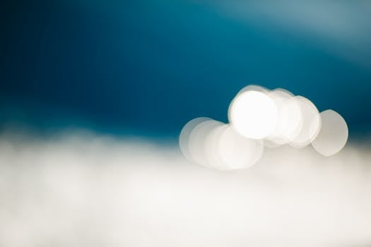 Blurred bokeh lights with blue backdrop, creating a serene abstract effect.