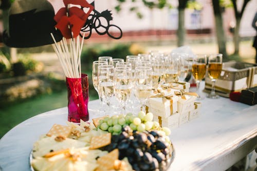 Champagne Glasses, Gift Boxes and Cheese, Grape and Crackers on Tray