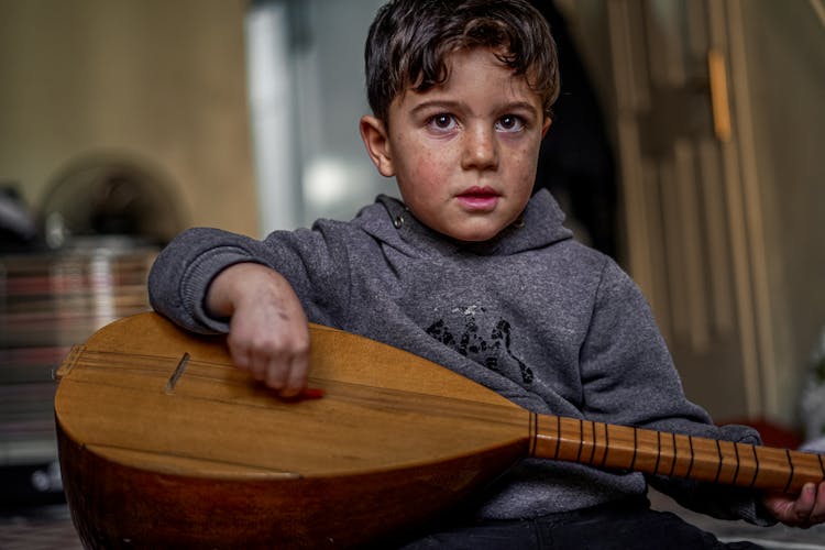 Boy Playing Traditional Musical Instrument