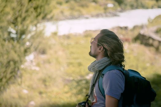 Woman in Gray Scarf and Black Backpack