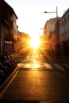 A picturesque street scene in Pozuelo de Alarcón during a stunning sunset with golden light glowing down the road.