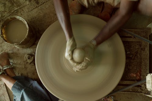 High-Angle Shot of a Person Making a Clay Pot