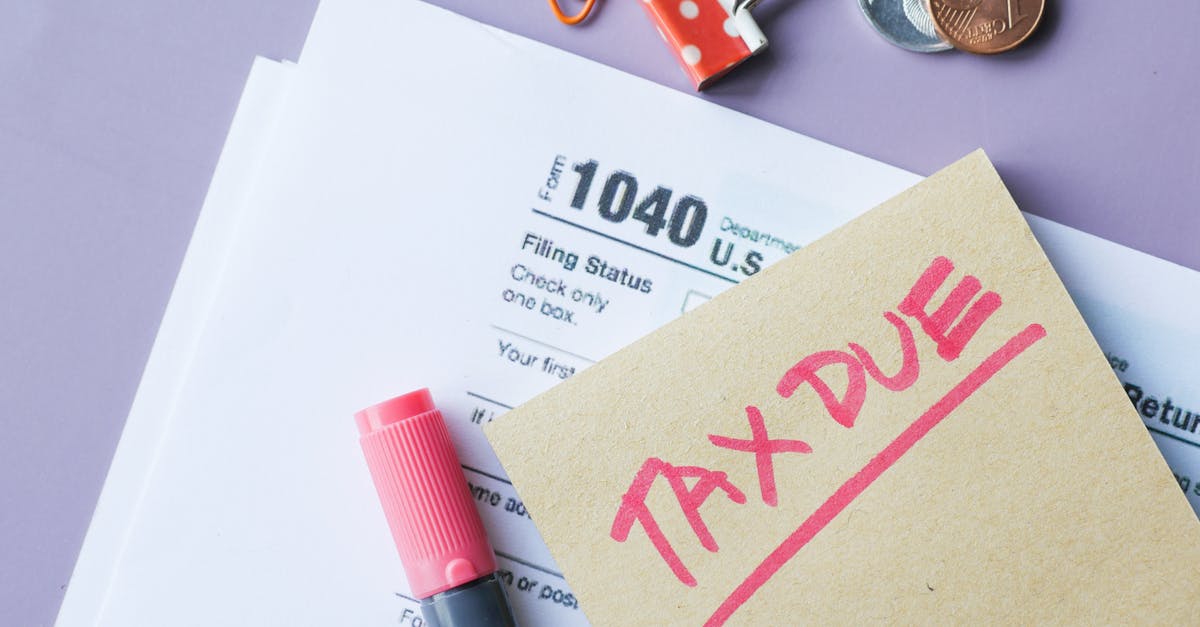 Close-up of IRS Form 1040 with 'Tax Due' note and stationery on a desk.