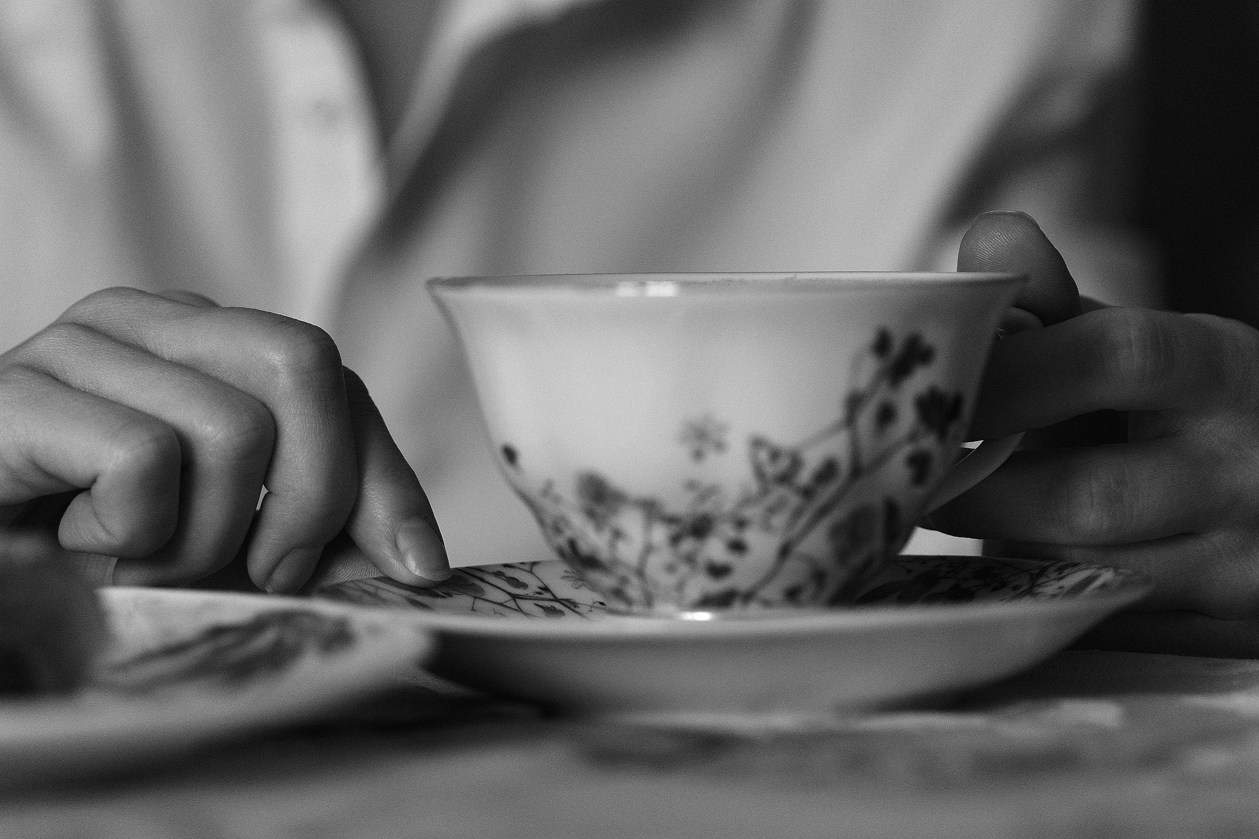 Hands holding a delicate vintage teacup with care, showing the emotional attachment collectors develop toward individual pieces.