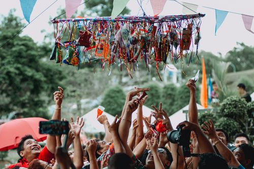 Free People joyfully participate in a traditional Filipino fiesta game outdoors. Stock Photo