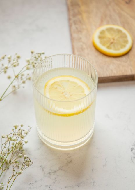 A glass of homemade lemonade with a lemon slice, perfect for a summer refreshment.