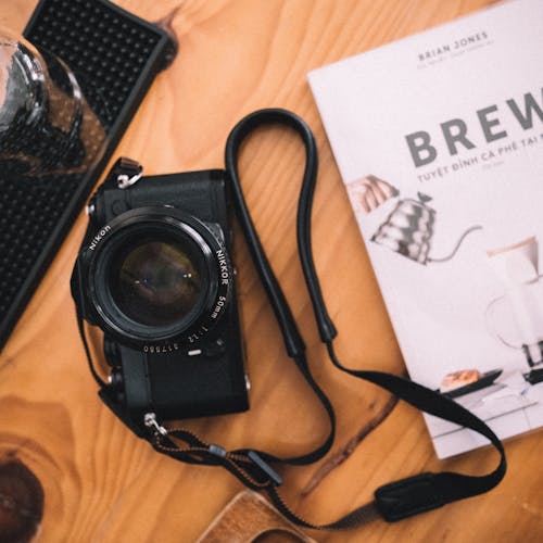 A Nikon Camera on Brown Wooden Surface