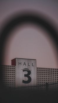 A modern building with the sign 'Hall 3' during twilight, showcasing industrial architecture.