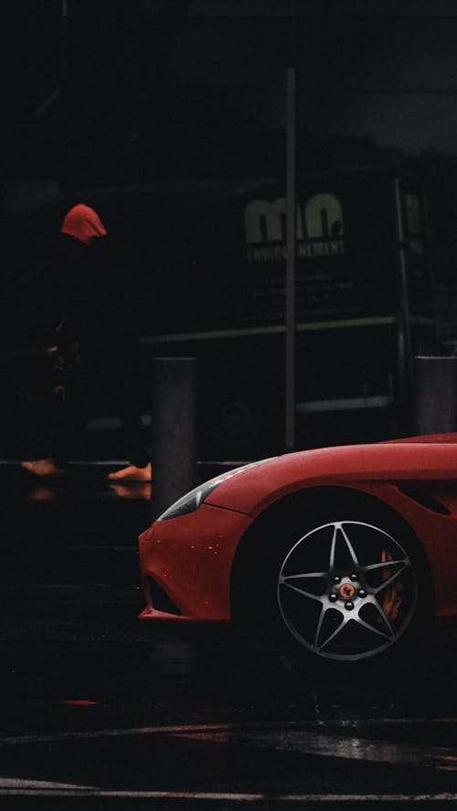 Free Red Ferrari Car Parked Near Building Stock Photo