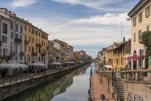 A picturesque view of a lively canal lined with colorful buildings and outdoor cafes.