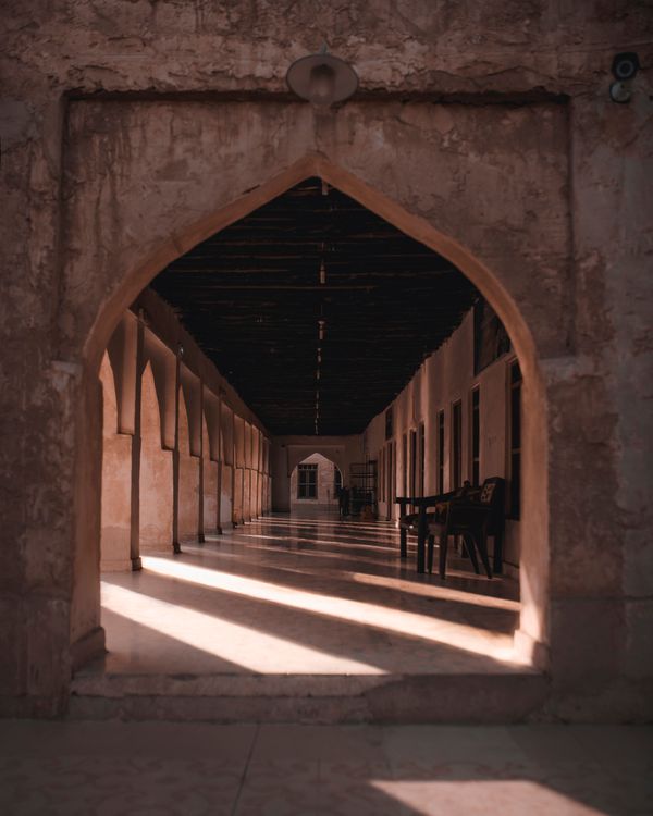 Arched doorway in shadow by Ömer Aydın on Pexels