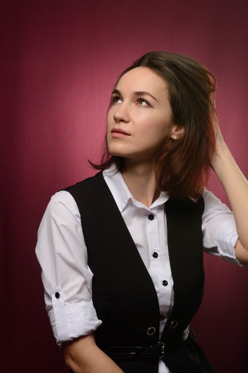 Woman in Black Vest and White Dress Shirt Looking Up  Free Stock Photo
