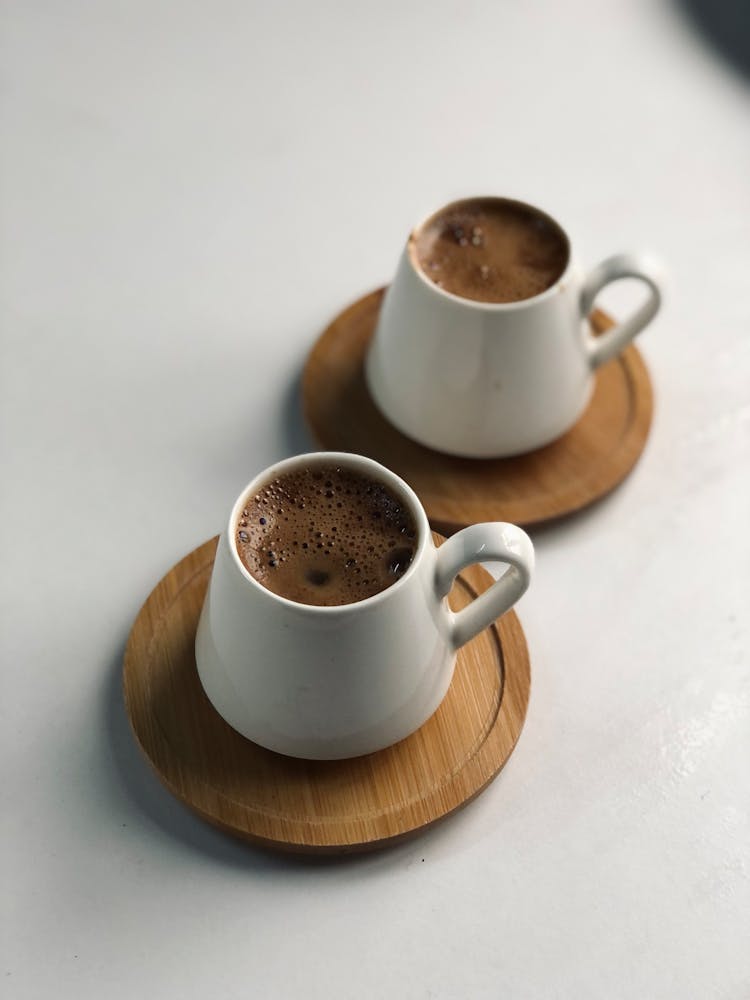 Two Cups Of Coffee On Wooden Saucers 