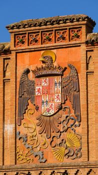 Vertical shot of a historic Spanish coat of arms in Toledo, Spain.