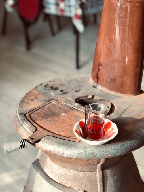 Free A traditional cup of Turkish tea on a rustic stove, creating a cozy kitchen ambiance. Stock Photo