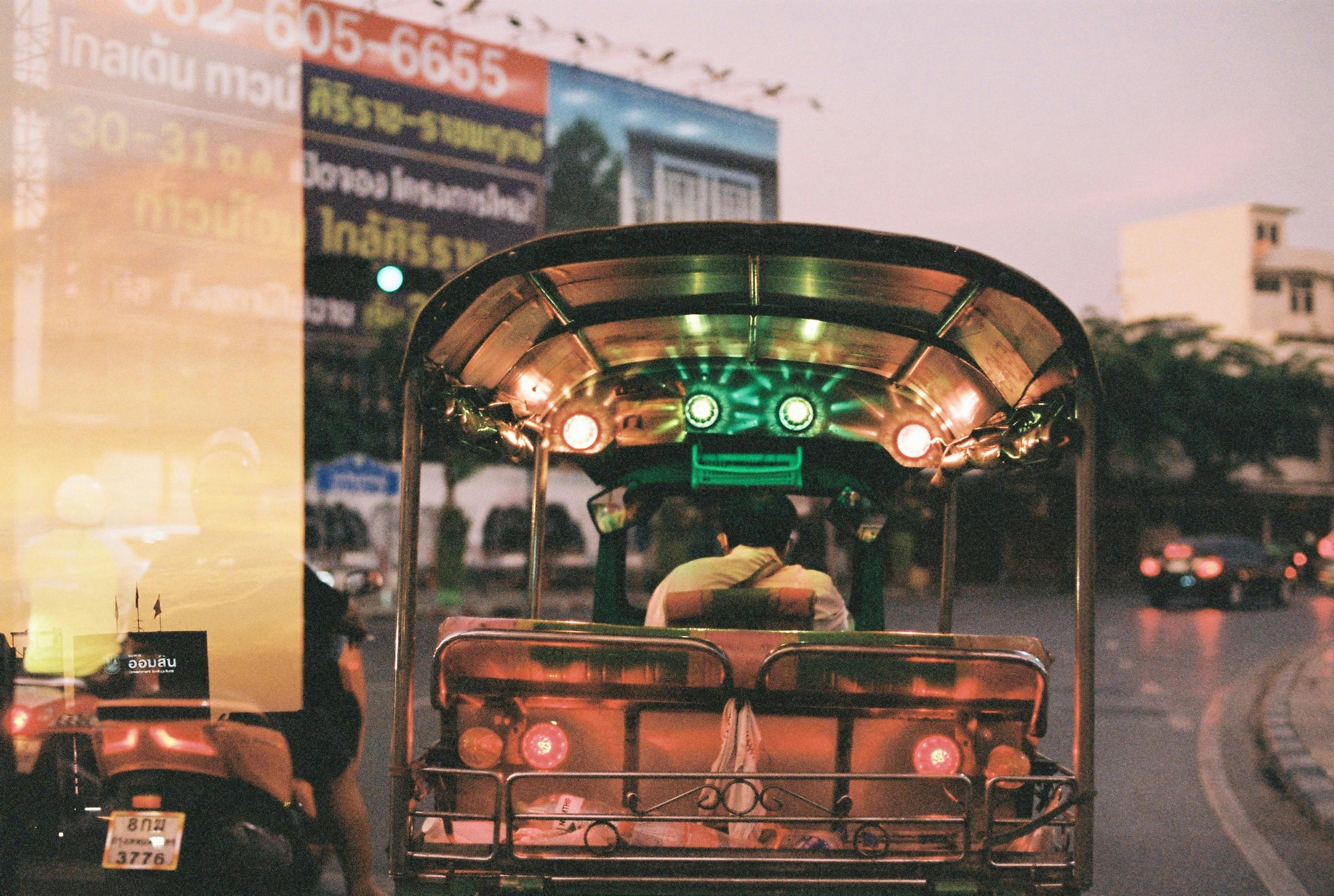 woman riding tuk tuk streets